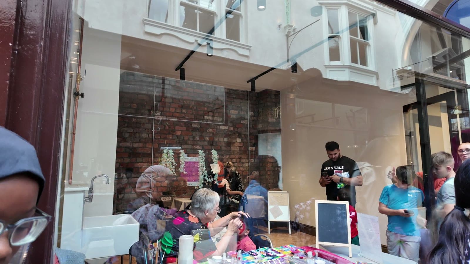 A craft workshop seen through the glass of a Dewsbury arcade unit
