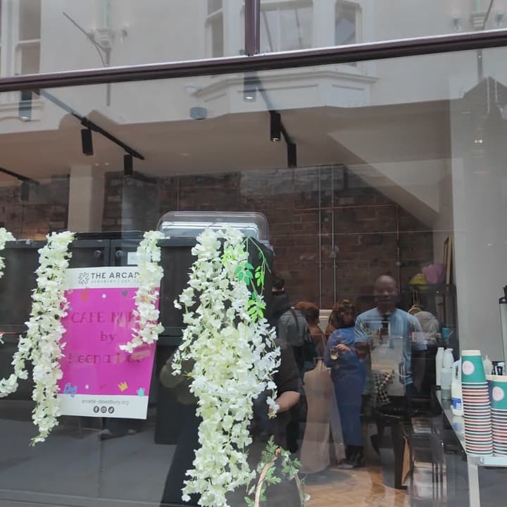 The arcade coffee kiosk dressed with a white flower garland